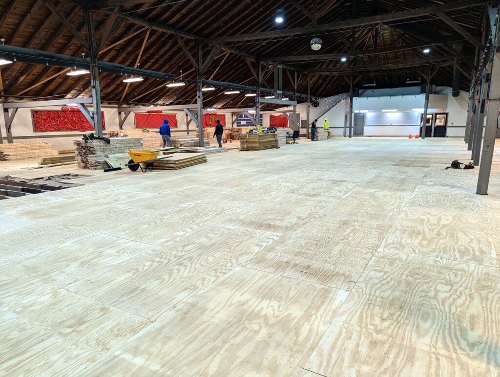 Subflooring on top of repaired joists and new insulation at Purcellville Roller Rink.