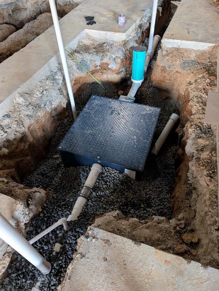 installation of plumbing and oil interceptor in ground slab of Detail Authority shop floor